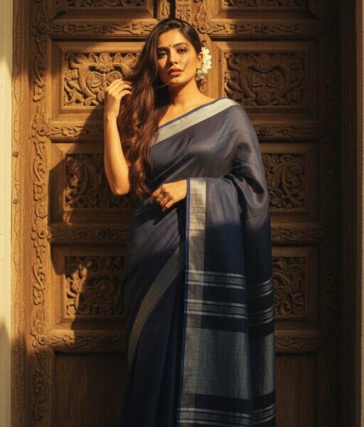 Blue linen cotton saree with silver zari detailing at the border and the aanchal