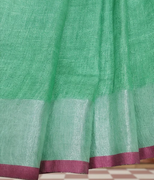 Pista green colour pure linen saree with very thin contrast border of dark pink colour and silver zari detailing at the border and aanchal - Image 3