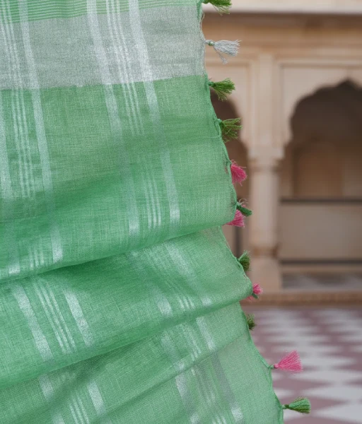Pista green colour pure linen saree with very thin contrast border of dark pink colour and silver zari detailing at the border and aanchal - Image 4